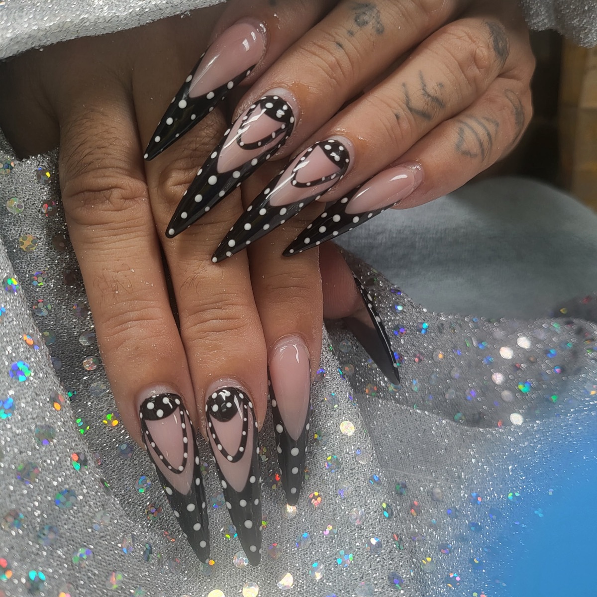 Long black and white dotted nail design, shared on Blue Rose Instagram
