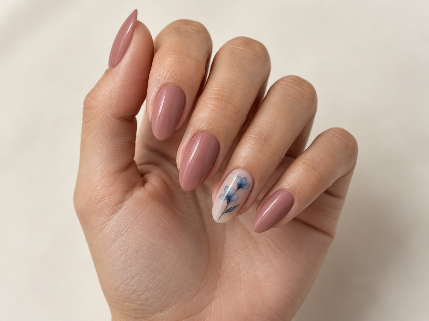 Illustrative image of almond-shaped rose-toned nail enhancements