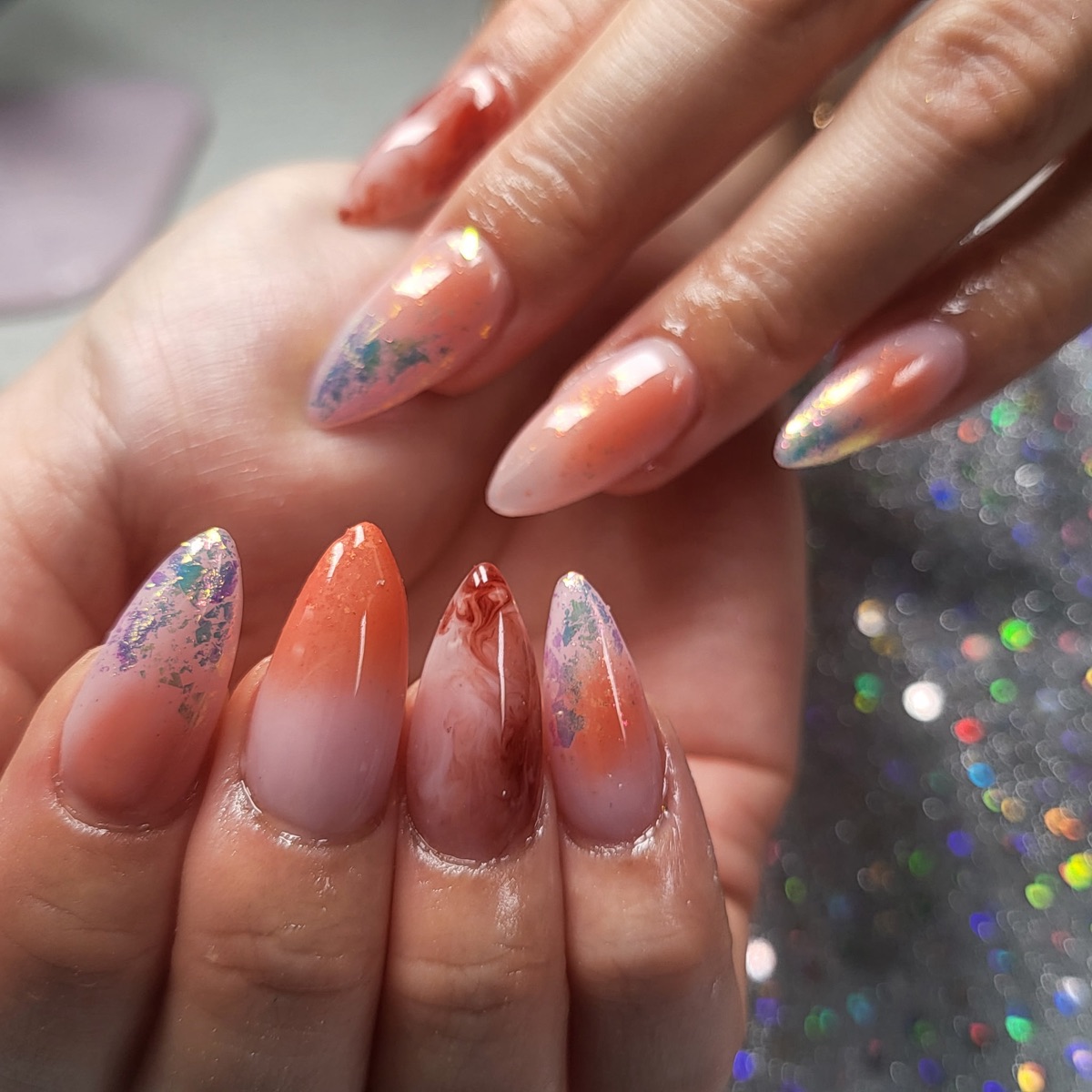 Peach-toned nails with iridescent shimmer, shared on Blue Rose Instagram