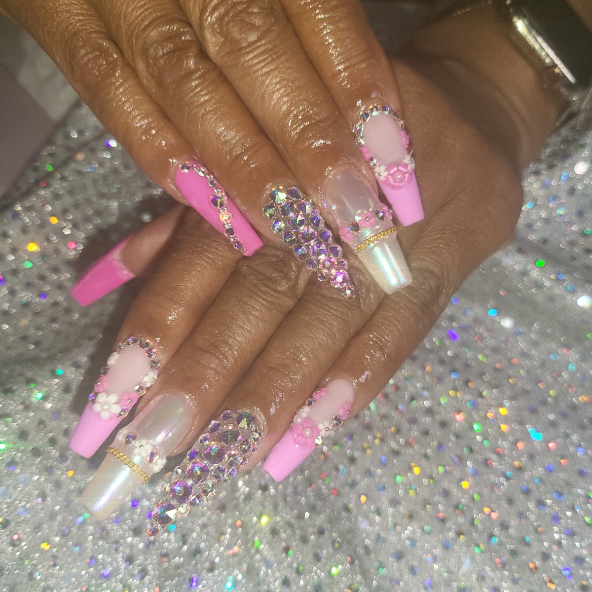 Pink nails with crystal details and floral accents, shared on Blue Rose Instagram