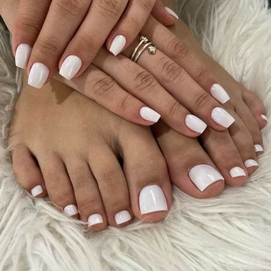 A fresh, glossy white pedicure finished at Bluerose Natural Nail