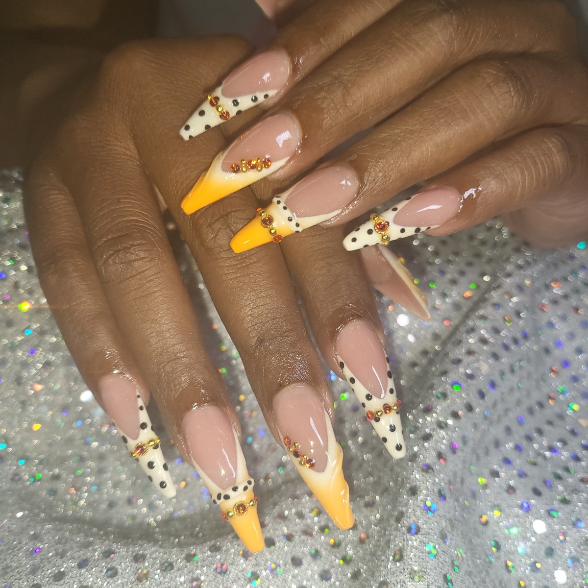 Long yellow nails with gold sparkle and a nude base, shared on Blue Rose Instagram
